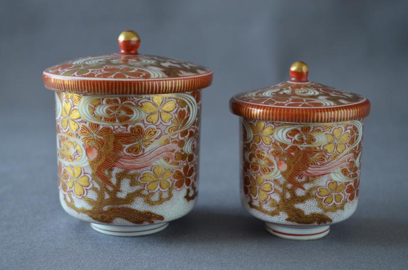 Pair teacups with design of Chinese phoenixes, cherry blossoms and stream, Kutani porcelain